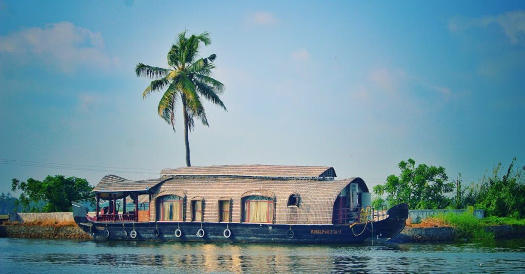 Picturesque view of river with green palms on bank and shabby wooden boathouse under blue sky in tropical countryside